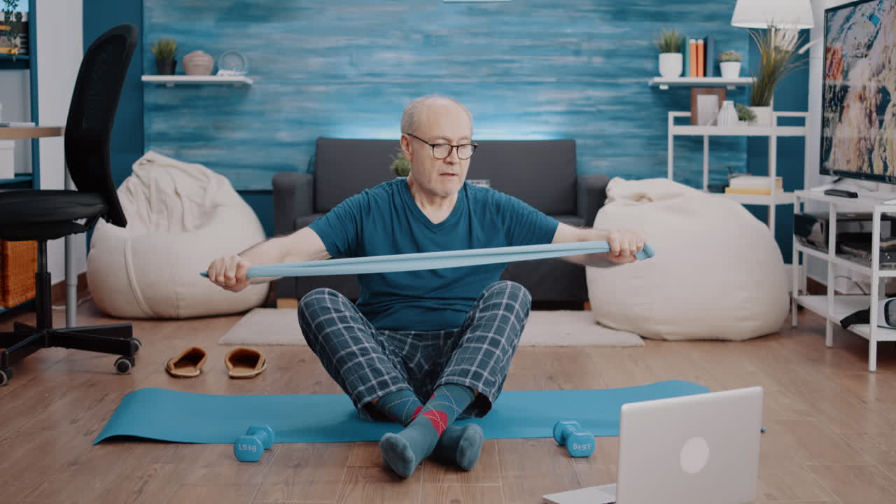 Senior person pulling flexible resistance band to exercise