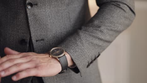 man put on wrist watch, groom dresses, male businessman waiting for meeting, hand with clock