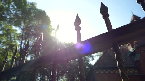 An-iron-fence-with-sharp-pointed-spikes-in-the-light-of-sunlight