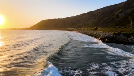 amazing drone shot of a beach in california during sunset golden hour