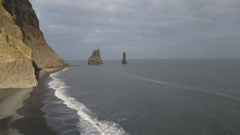 reynisfjara playa de arena negra y pilas en el fondo, islandia
