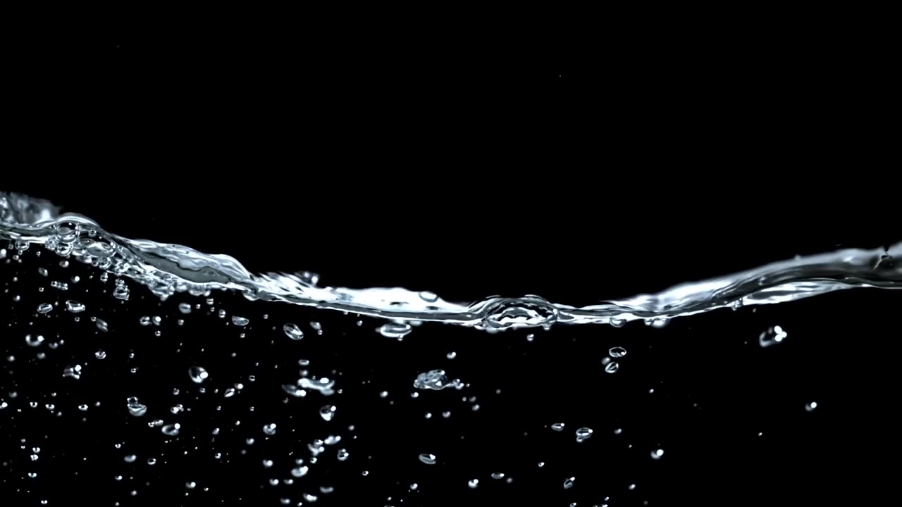 Close-up of Clear Water Splashing and Bubbling on a Black Background