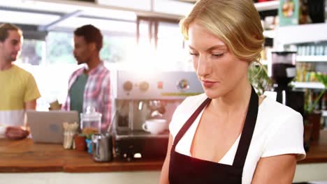 Portrait-of-waitress-standing-behind-the-counter