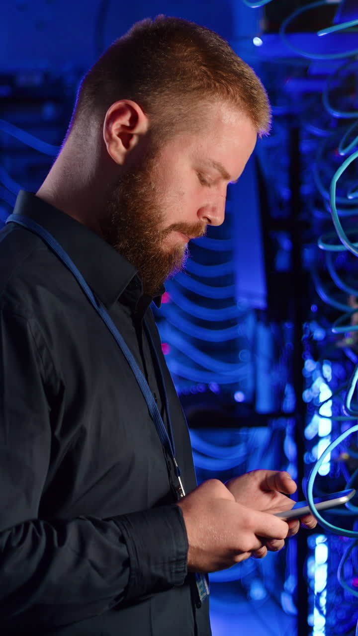 Man analysing data in a server room. Vertical