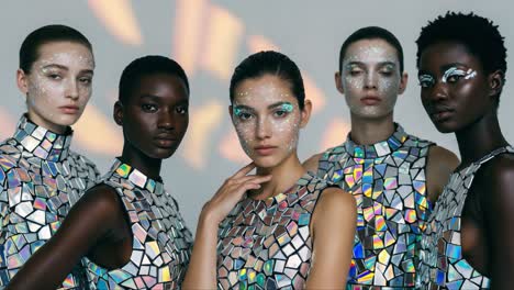 striking visuals of a diverse group of models showcasing stunning mosaic fashion and dazzling makeup in a contemporary artistic presentation