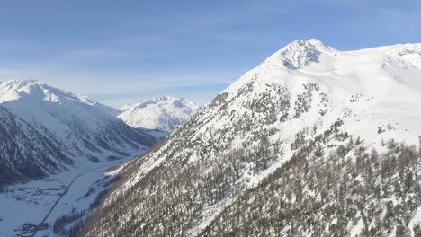 aerial landscape of alpine valley placed among high peaks and steep slopes