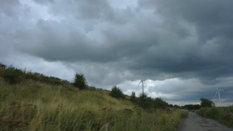 tracking shot of turning wind turbine on cloudy day 2