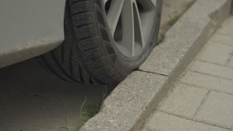 Close-up-of-a-badly-parked-car-with-tyre-on-curb