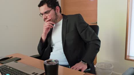 Man Focused on Laptop in Office Setting