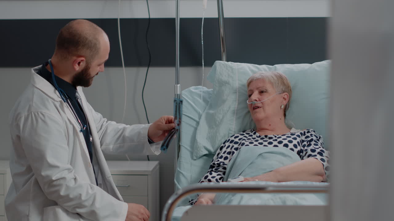 Doctor and old patient analyzing radiography for healthcare