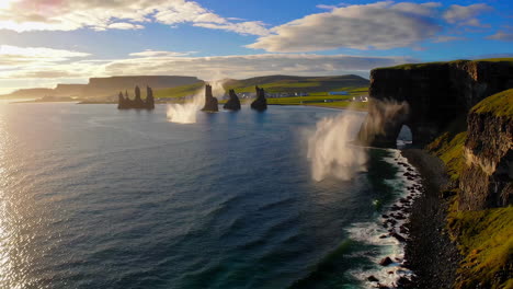 dramatic waves crashing against reynisdrangar sea stacks and dyrhólaey cliffs in iceland
