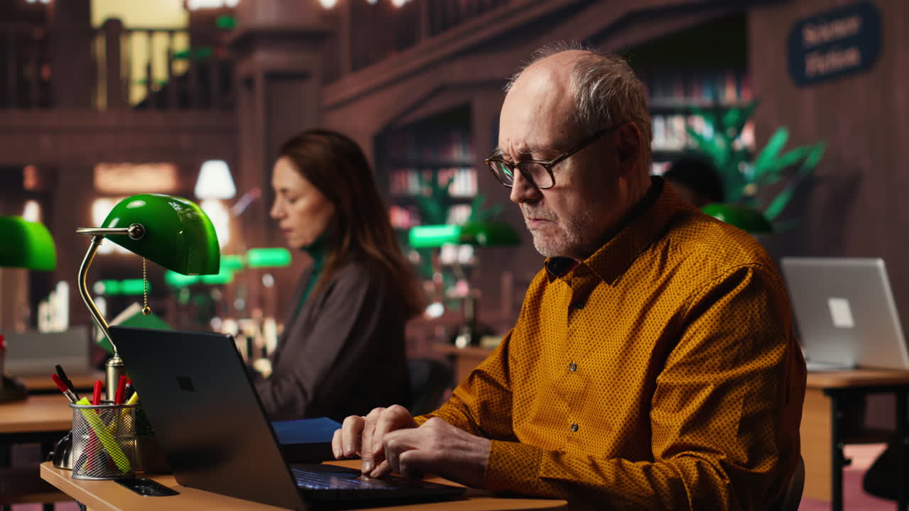 People working at desks in a library