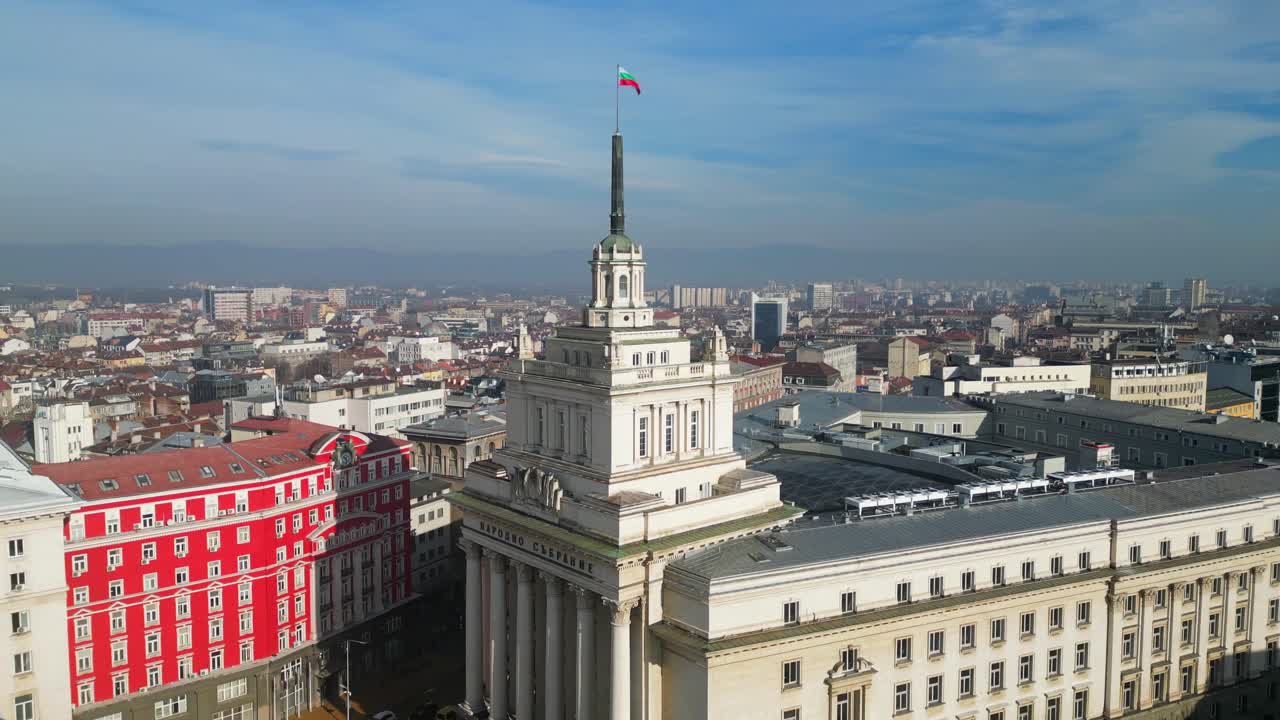 Flag waving at the top of the public square The Largo, President's office, and Council of Ministers buildings of Bulgaria, Sofia