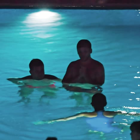 swimming pool at a luxury, tropical resort at night