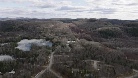 ice-covered lake with mountains and forest at daytime in tremblant, canada