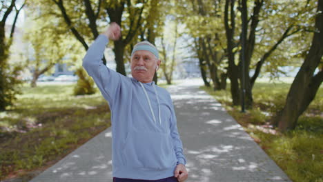 Athletic-senior-sport-man-grandfather-training-running,-celebrating-finish-success-race-win-victory