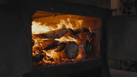 wood burning on the fireplace inside the house during winter