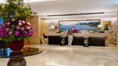 motion of hotel reception counter with customer asking about check in question with 4k resolution