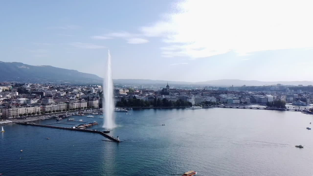 Aerial circling the Jet d'Eau fountain in Geneva on sunny day, Switzerland