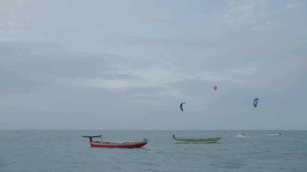 Coastal Scene with Small Fishing Boats and Kitesurfers at Sea STATIC
