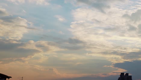 a colorful sunset surfing clouds, blue and yellow, orange sky, time lapse, 4k video