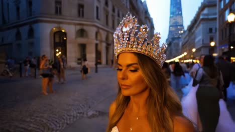 woman in crown on city street at night