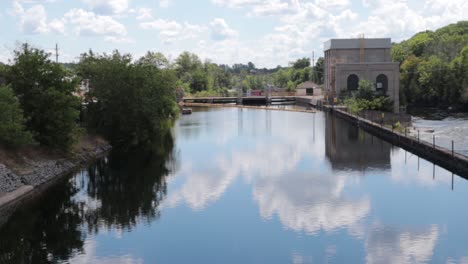 static nature shot of scenic dammed river and levee building