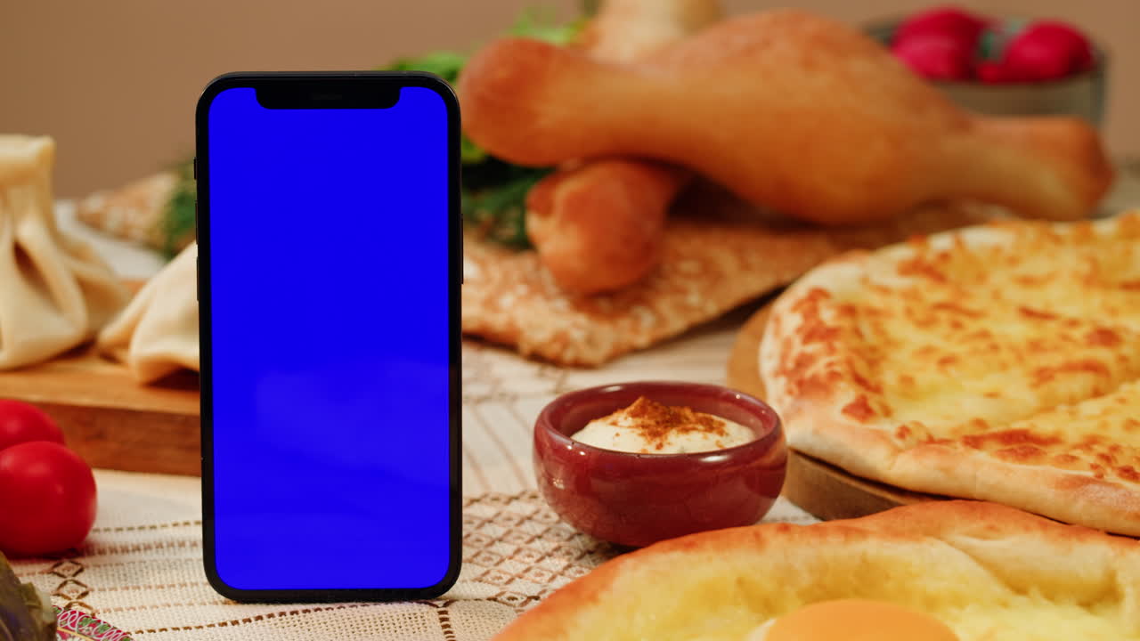 Mobile phone on a table with Georgian food