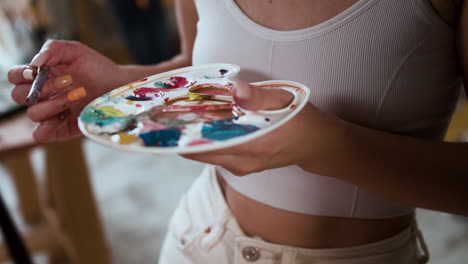 two people painting indoors