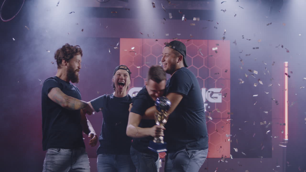 Gaming Tournament Team Celebrating their Victory Medium Shot of a Gaming Tournament Team Holding their Prize while Celebrating their Victory