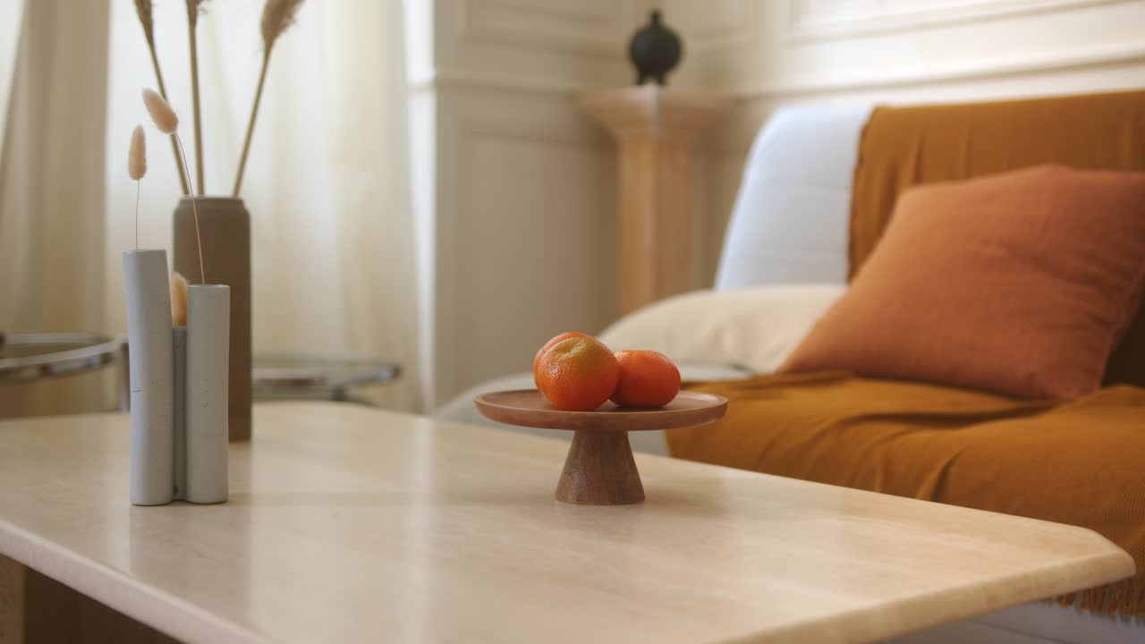 Slow zoom in shot of a living room table with some furnishing objects on