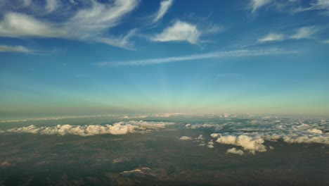 quiet winter sky at sunset, a pilot’s perspective shot from an airplane cabin fliying over mallorca island, spain, at 4000m high