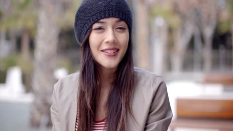 cute smiling young woman in knitted hat