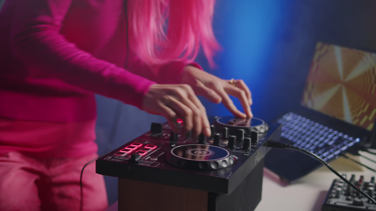 DJ performing with mixer and laptop