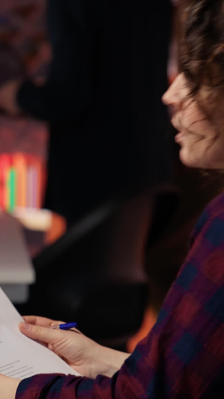 Vertical video Tech startup HR employee analyzing candidates for job opening, reviewing resumes