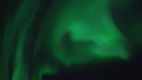 the northern lights filmed in real time over mountain landscape on the island kvaløya near tromsø in nothern norway