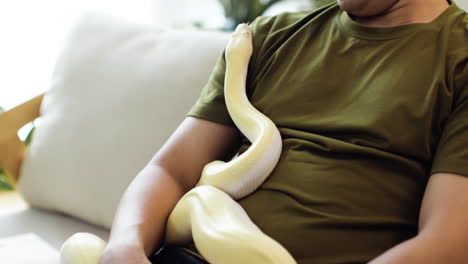 man with snake indoors