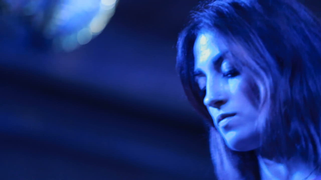 Artist performs songs from stage during concert at nightclub