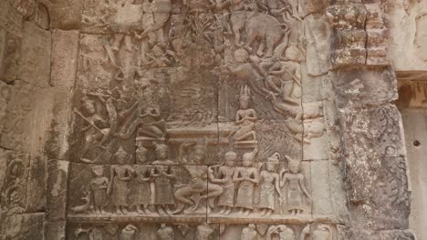 upwards tilt showing wall art from the temples of angkor wat. 4k.