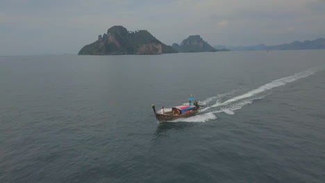 aerial of water taxi boat off the coast of thailand at sunset