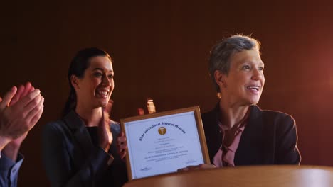 Female-business-executive-receiving-award