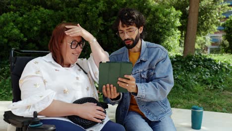 two people conversing outdoors in a park