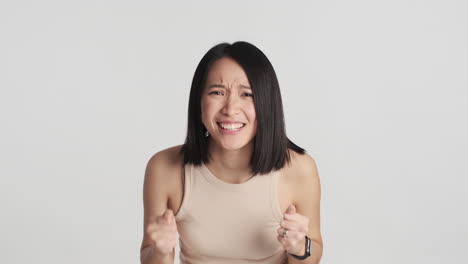 asian woman celebrating victory on camera.