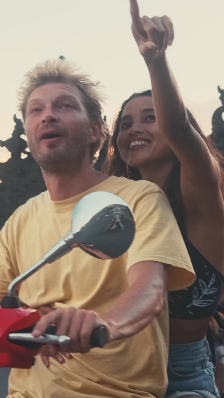 Couple riding a scooter during vacation in southeast asia