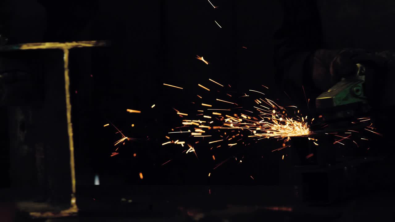 Two welders working in workshop