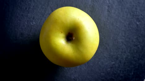 extreme macro closeup top down shoot of tasty green apple rotating around in motion