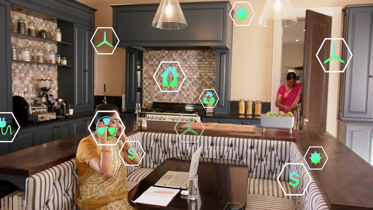 Woman in yellow sari writing at banquette, writing causing energy icons floating, daughter entering