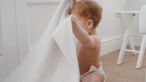 funny baby boy at home playing with blanket happy toddler learning having fun exploring childhood 4k