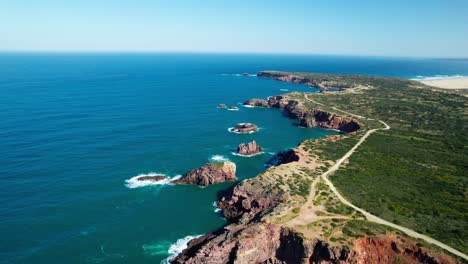 aerial view of rocky coastline, blue sea and green