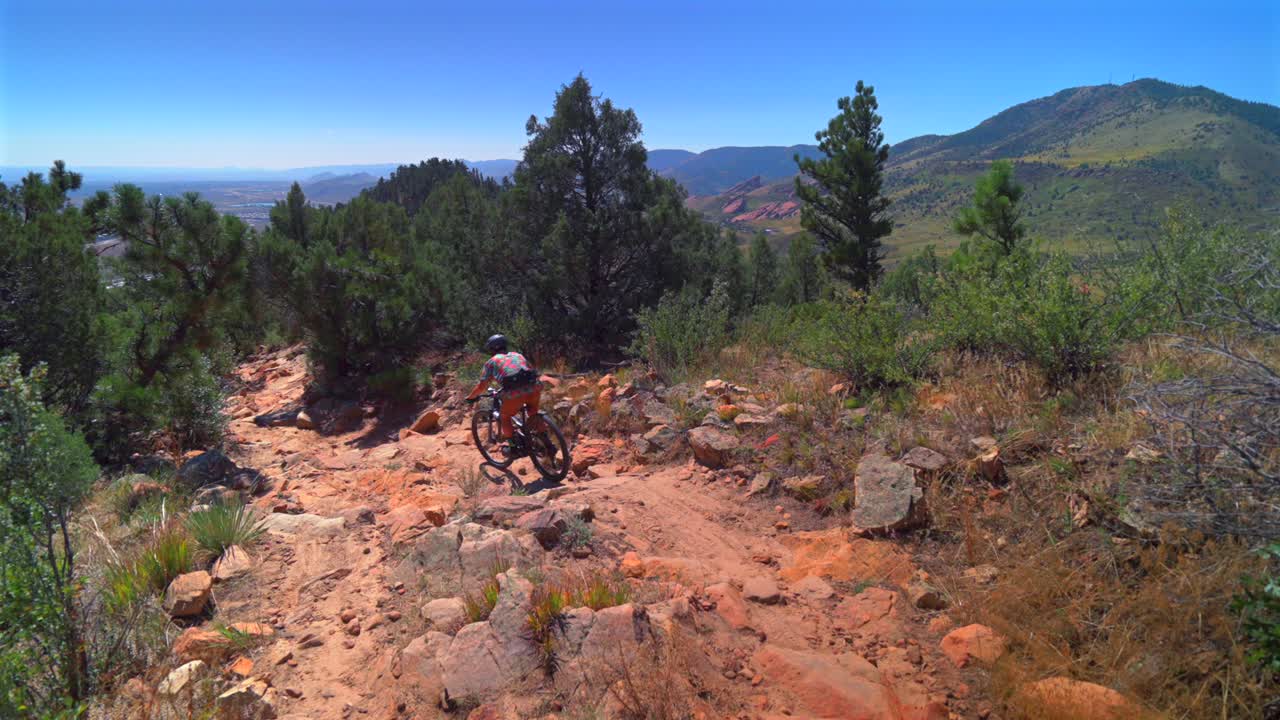 Red Rocks Morrison Golden Colorado adult male mountain biking biker downhill boulders static shot Dinosaur Ridge Dakota Ridge Trail sport fitness Denver foothills front range sunny day